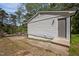 Exterior side view of home showing vinyl siding, back door entrance, and part of the driveway at 120 King Charles Rd, Hillsborough, NC 27278