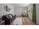 Inviting living room featuring wood floors, a comfortable sofa, natural light, and stylish decor at 120 King Charles Rd, Hillsborough, NC 27278