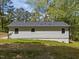 The rear exterior of the home features light siding, a gray roof, and a well-maintained lawn at 120 King Charles Rd, Hillsborough, NC 27278