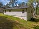 The rear exterior of the home features light siding, a gray roof, and a well-maintained lawn at 120 King Charles Rd, Hillsborough, NC 27278