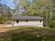 The rear exterior of the home features light siding, a gray roof, and a well-maintained lawn at 120 King Charles Rd, Hillsborough, NC 27278