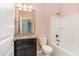 Well-lit bathroom featuring granite countertops, a dark vanity, and a shower-tub combination at 1206 Areca Way, Durham, NC 27703