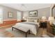 Bedroom featuring hardwood floors, a neutral color scheme, and a large window with plantation shutters at 1206 Areca Way, Durham, NC 27703