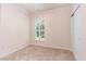 Cozy bedroom with neutral carpet, shuttered window for natural light, and a closet for storage at 1206 Areca Way, Durham, NC 27703