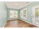 Cozy empty room bathed in light, featuring hardwood floors and plantation shutters at 1206 Areca Way, Durham, NC 27703