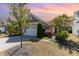 Charming single-story home with a manicured lawn, inviting entrance, and a two-car garage under a colorful sunset at 1206 Areca Way, Durham, NC 27703