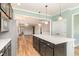 Bright kitchen with dark island, stainless appliances, pendant lighting, and hardwood floors at 1206 Areca Way, Durham, NC 27703