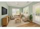 Inviting living room with natural light, light green walls, and modern furniture at 1206 Areca Way, Durham, NC 27703
