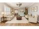 Bright living room with hardwood floors, neutral furniture, and access to other rooms at 1206 Areca Way, Durham, NC 27703
