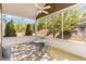 Relaxing sunroom with tile flooring, ceiling fan, and views of the well-maintained backyard at 1206 Areca Way, Durham, NC 27703