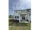 Backyard view featuring a covered patio, a small yard, and a white fence at 1214 Tredenham Way, Durham, NC 27703