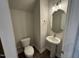 Cozy powder room with pedestal sink, modern lighting, and neutral decor, creating a welcoming space at 1214 Tredenham Way, Durham, NC 27703