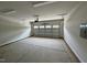 Clean and spacious two-car garage featuring concrete floors and an automatic door opener for convenient access at 1214 Tredenham Way, Durham, NC 27703