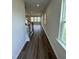 Inviting hallway featuring beautiful hardwood floors and staircase leading to a spacious living area at 1214 Tredenham Way, Durham, NC 27703