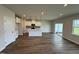 Bright and airy living room and kitchen space, showcasing hardwood floors and abundant natural light at 1214 Tredenham Way, Durham, NC 27703