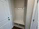 Functional mudroom area with built-in bench and storage hooks, providing a convenient and organized entryway at 1214 Tredenham Way, Durham, NC 27703