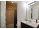 Well-lit bathroom features a shower with blue patterned curtain and a sleek vanity with a white sink at 123 Charndon Way, Fuquay Varina, NC 27526