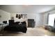 A bedroom featuring a black bed and dresser set, jerseys hanging on the wall, and a window for natural light at 123 Charndon Way, Fuquay Varina, NC 27526
