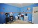A bedroom with blue walls, sports-themed decor, a desk and storage space, carpeted flooring and a small window at 123 Charndon Way, Fuquay Varina, NC 27526