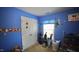 A cozy carpeted bedroom with blue walls, baseball decor, carpeted floors, and a window for natural light at 123 Charndon Way, Fuquay Varina, NC 27526
