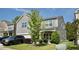 Attractive two-story house with well-kept lawn and beautiful landscaping, complemented by ample parking in the driveway at 123 Charndon Way, Fuquay Varina, NC 27526