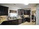 Bright kitchen with stainless steel appliances, tile backsplash, and dark wood cabinets, offering style and functionality at 123 Charndon Way, Fuquay Varina, NC 27526