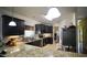 Modern kitchen with granite countertops, stainless steel appliances, and sleek dark brown cabinetry at 123 Charndon Way, Fuquay Varina, NC 27526
