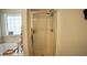 Bright bathroom featuring a glass shower, soaking tub, and decorative window with natural light at 123 Charndon Way, Fuquay Varina, NC 27526