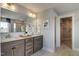 Elegant bathroom with double vanity, granite countertops, and a walk-in closet entrance at 125 Verona Villa Dr, Burlington, NC 27215