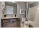 Cozy bathroom boasts granite countertop, modern fixtures and shower with curtain at 125 Verona Villa Dr, Burlington, NC 27215