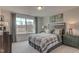 Bright bedroom featuring a plaid comforter, large window, and owl artwork at 125 Verona Villa Dr, Burlington, NC 27215