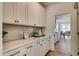 Well-appointed butler's pantry with white cabinetry, quartz countertops, and stylish backsplash at 125 Verona Villa Dr, Burlington, NC 27215