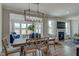 Elegant dining room with modern lighting, a fireplace and backyard views at 125 Verona Villa Dr, Burlington, NC 27215