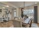 Bright dining room featuring a long wooden table, comfortable seating, and a modern chandelier at 125 Verona Villa Dr, Burlington, NC 27215