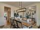 Open-concept dining area with a large table, elegant chairs, stylish lighting, and beautiful decor at 125 Verona Villa Dr, Burlington, NC 27215