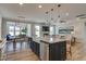 Open-concept living space featuring a modern kitchen with island seating, and an adjacent dining area at 125 Verona Villa Dr, Burlington, NC 27215