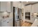 Bright kitchen featuring stainless steel refrigerator, white cabinetry, and modern appliances at 125 Verona Villa Dr, Burlington, NC 27215