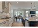 Bright open-concept kitchen with modern appliances, countertop seating, and access to dining area at 125 Verona Villa Dr, Burlington, NC 27215