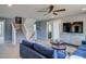 Bright living room featuring blue sofas, a ceiling fan, and a TV at 125 Verona Villa Dr, Burlington, NC 27215