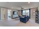 Bright living room featuring blue sofas, a ceiling fan, and a TV at 125 Verona Villa Dr, Burlington, NC 27215