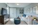Stylish living room features a comfortable sofa, ottoman, and shelving with decorative items at 125 Verona Villa Dr, Burlington, NC 27215