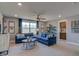 Bright living room featuring blue sofas, a ceiling fan, and lots of light at 125 Verona Villa Dr, Burlington, NC 27215