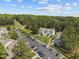 An aerial view shows a condominium complex, surrounded by lush trees, with ample parking available at 128 Schultz St, Chapel Hill, NC 27514