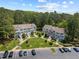 Aerial view of condominium complex featuring manicured lawns, mature trees, and parking at 128 Schultz St, Chapel Hill, NC 27514