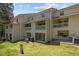 View of the back of a condominium complex featuring a covered porch and well-maintained lawn at 128 Schultz St, Chapel Hill, NC 27514