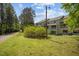View of a condominium complex surrounded by lush greenery and a well-maintained lawn at 128 Schultz St, Chapel Hill, NC 27514