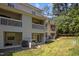Backyard view of townhomes featuring balconies, patios, and green lawns at 128 Schultz St, Chapel Hill, NC 27514