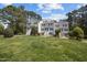 Exterior view of two-story townhomes featuring well-manicured lawns and trees at 128 Schultz St, Chapel Hill, NC 27514
