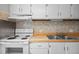 A close up of a kitchen with tile flooring, white appliances, wood countertops, and ample cabinet space at 128 Schultz St, Chapel Hill, NC 27514