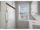 A laundry room with white appliances, upper and lower cabinets, and a window view to the exterior at 128 Schultz St, Chapel Hill, NC 27514